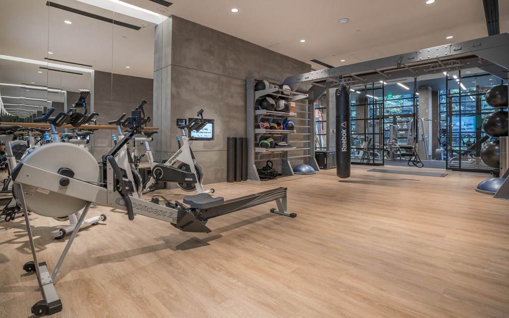 a gym with weights and other exercise equipment on a wooden floor