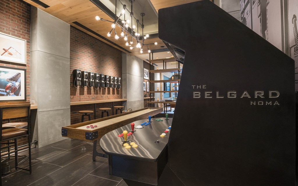 a billiards table in a room with a bar and a scoreboard