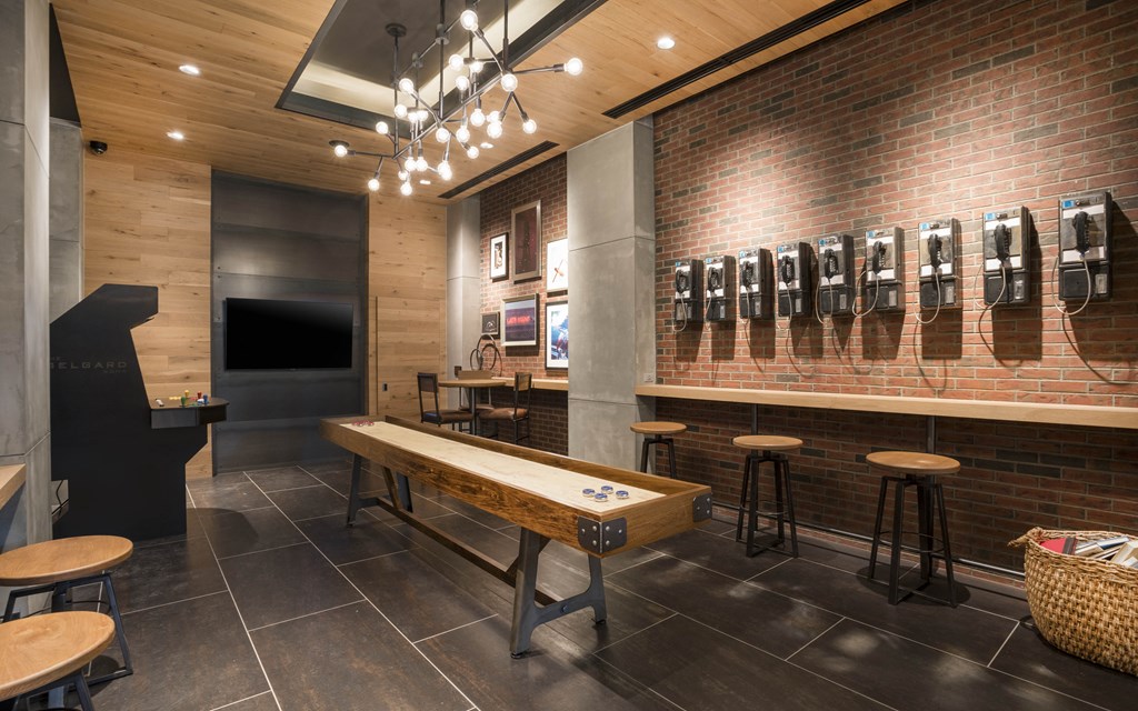 a sports bar with a shuffleboard table and a television