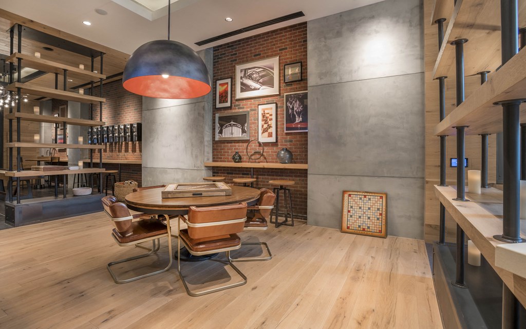 a dining room with a table and chairs and a brick wall