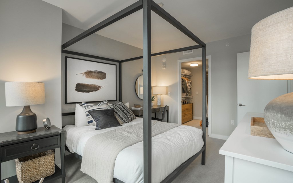 a bedroom with a large bed and a large fish painting on the wall