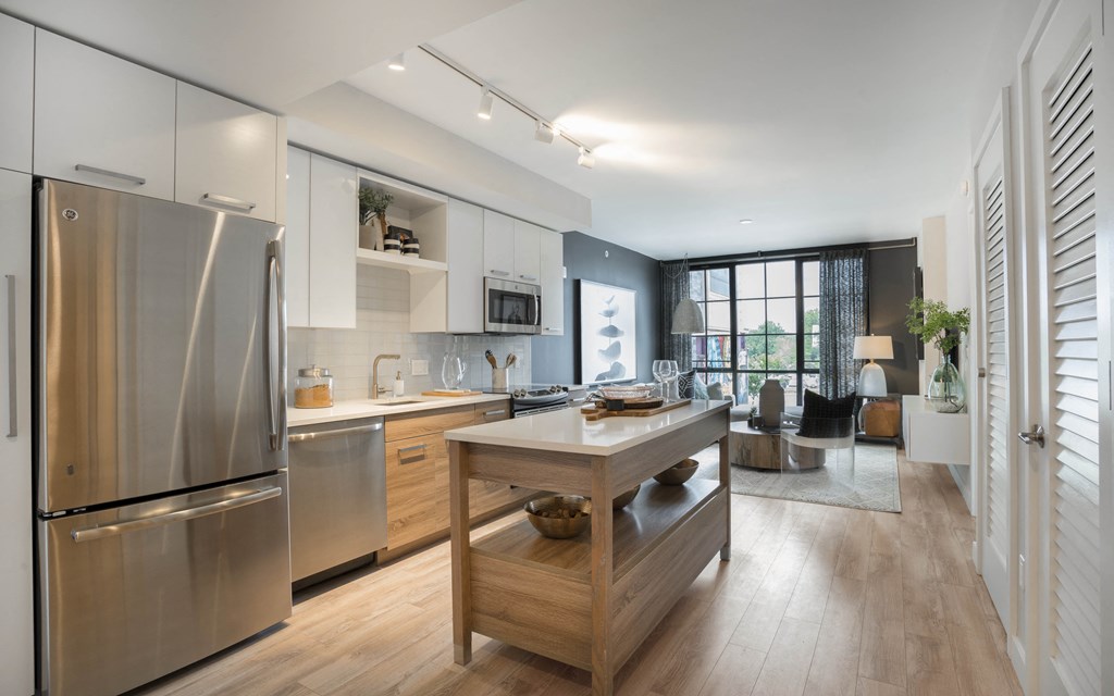 a kitchen with stainless steel appliances and a wooden island
