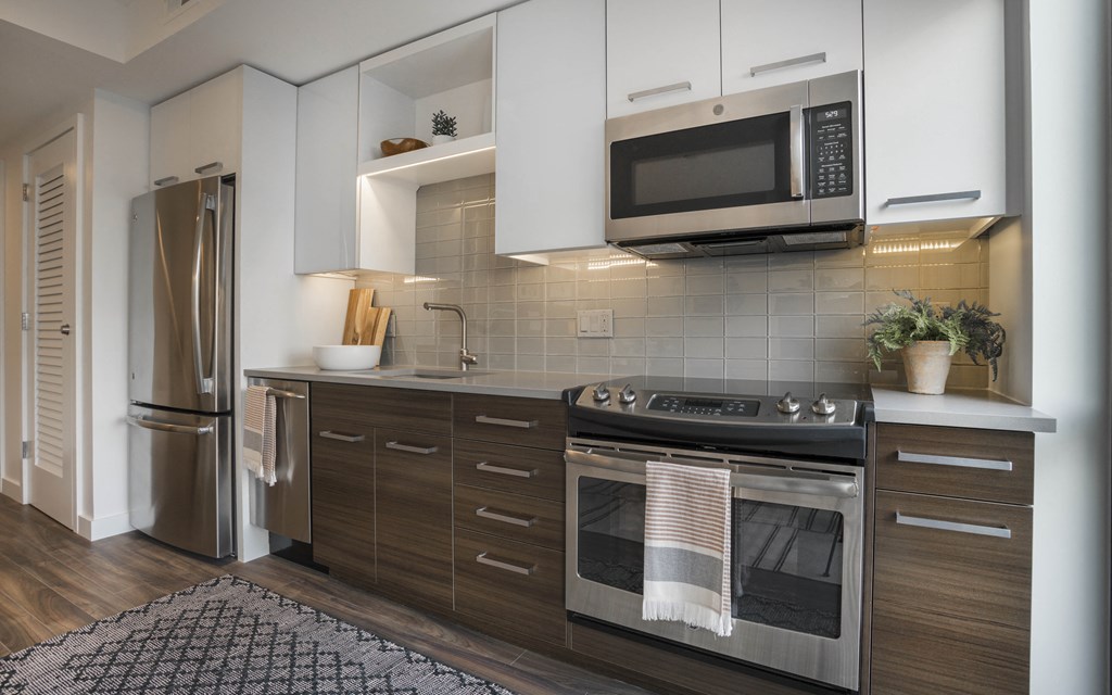 a kitchen with stainless steel appliances and white cabinets