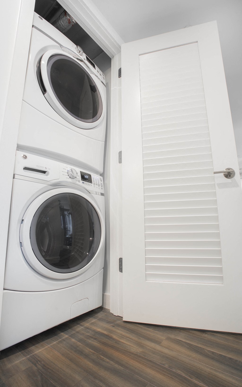 a white washer and dryer in a white closet