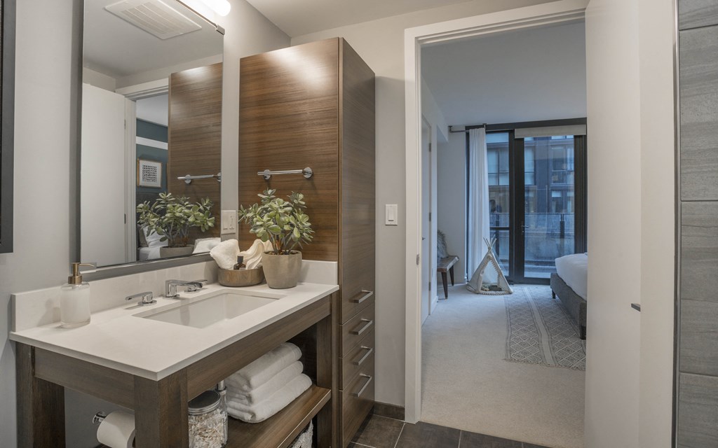 a bathroom with a sink and a mirror in a hotel room