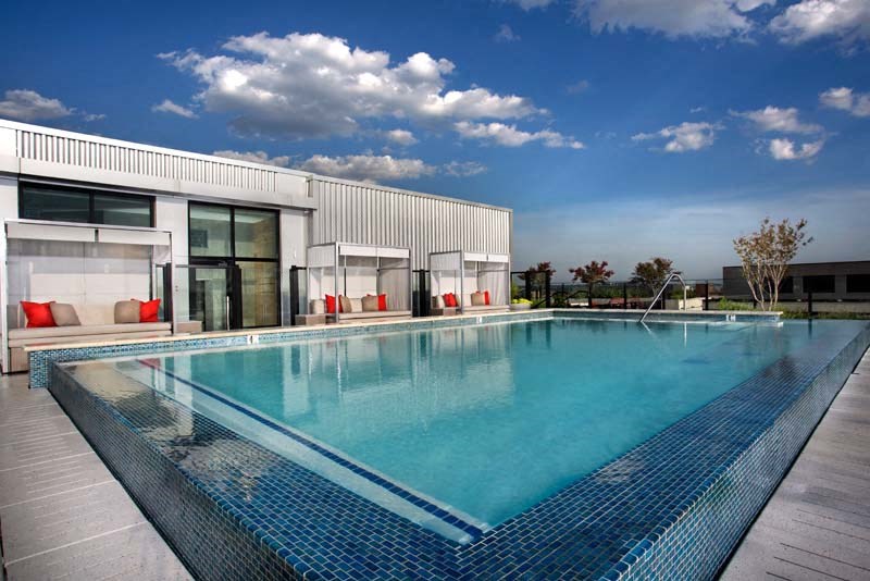 a large swimming pool in front of a building