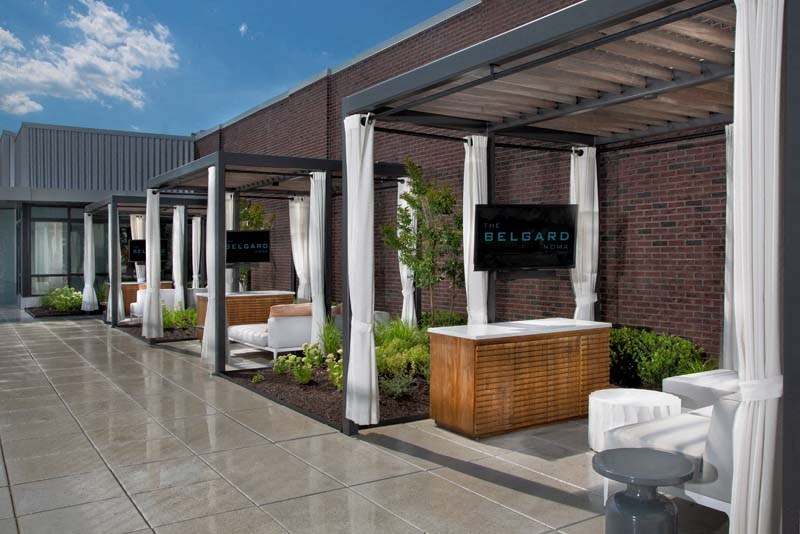 the exterior of a building with a patio and a bar