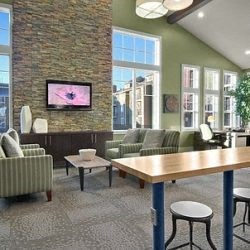 a living room with couches chairs and a table