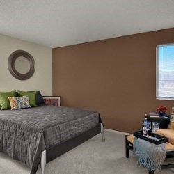 a bedroom with a bed and a couch