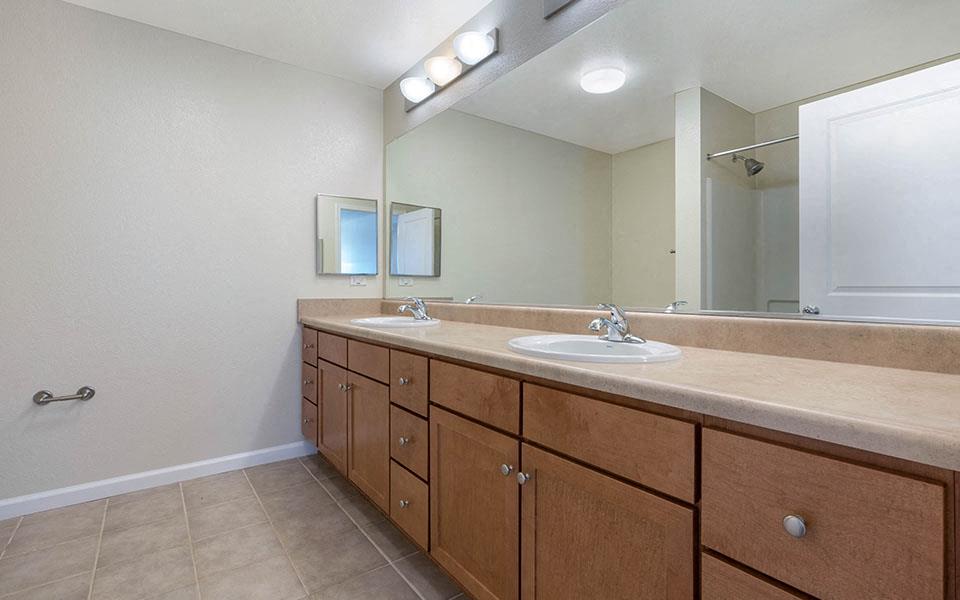 a bathroom with two sinks and a mirror