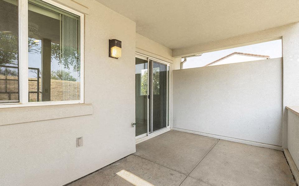 an empty porch with a sliding glass door
