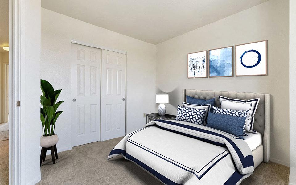 a bedroom with a bed and a potted plant