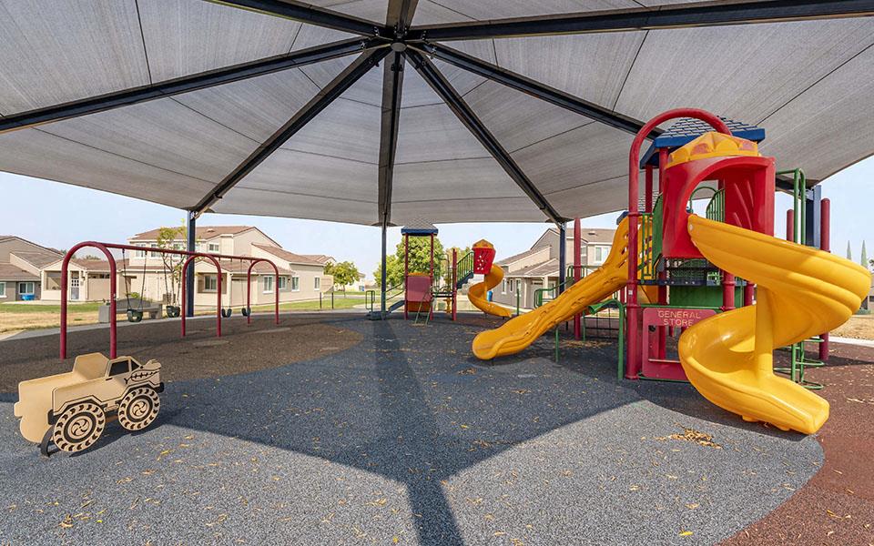a playground with slides and other toys in a tent