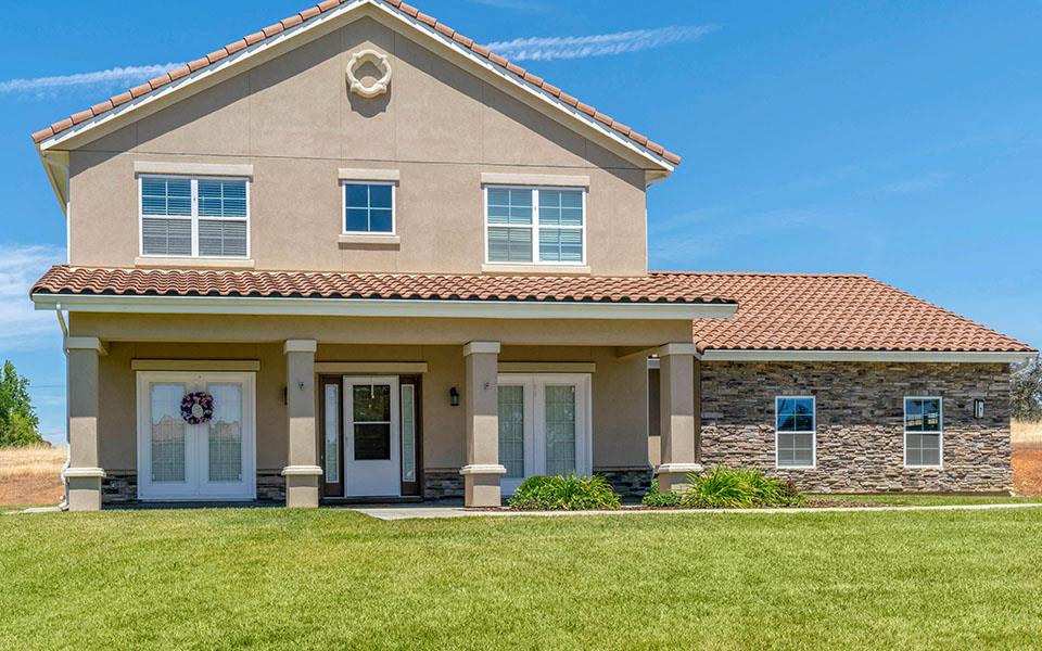a large house with a lawn in front of it