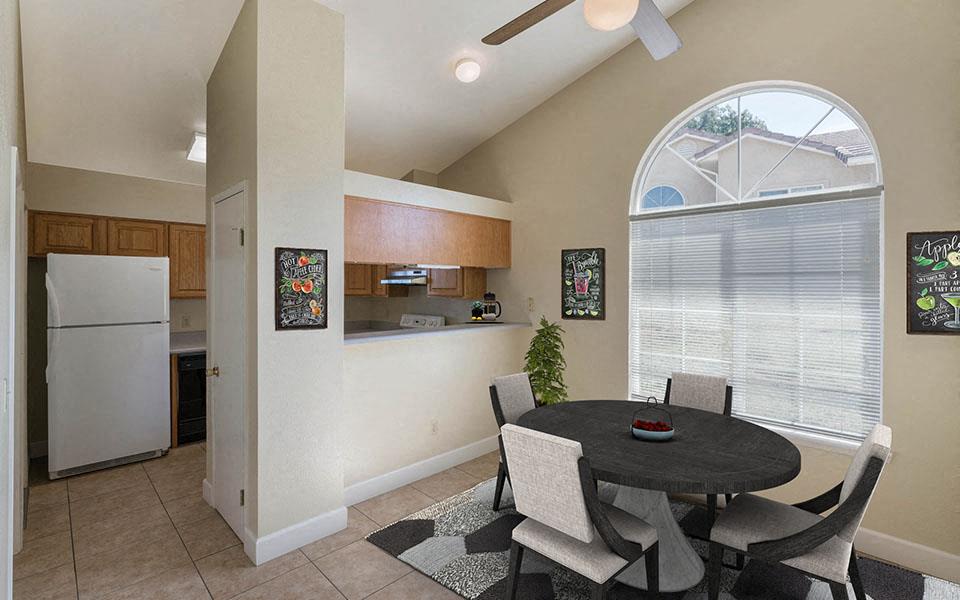 a kitchen and dining room with a table and chairs