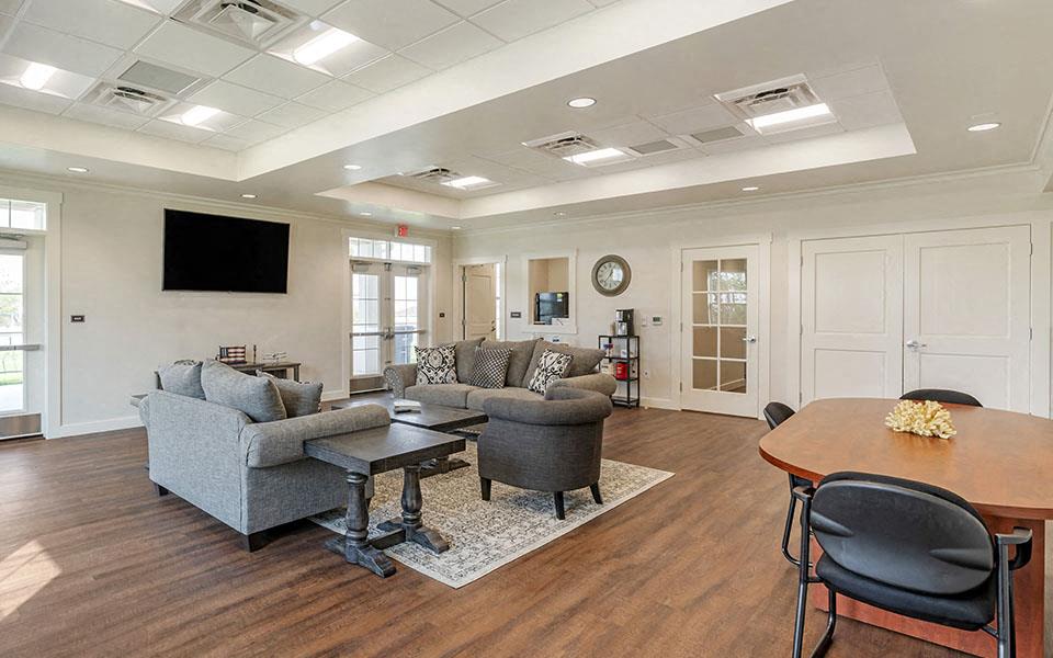 a living room with couches and chairs and a table