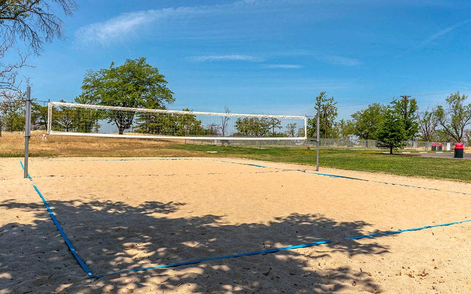 a volleyball court on the sand in a park