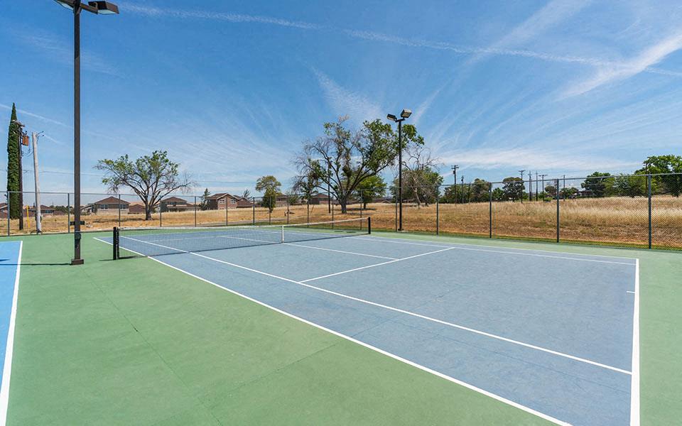 a tennis court with a fence around it