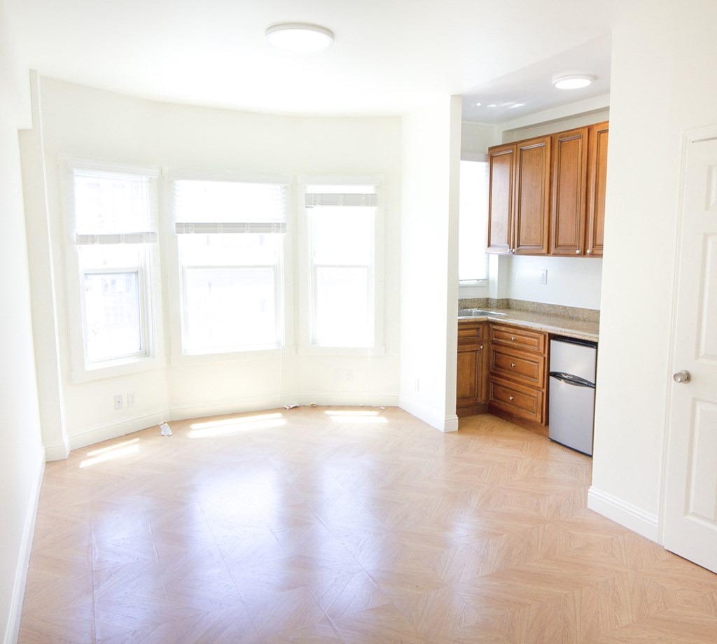 Open-concept living room and kitchen area with upgraded appliances.