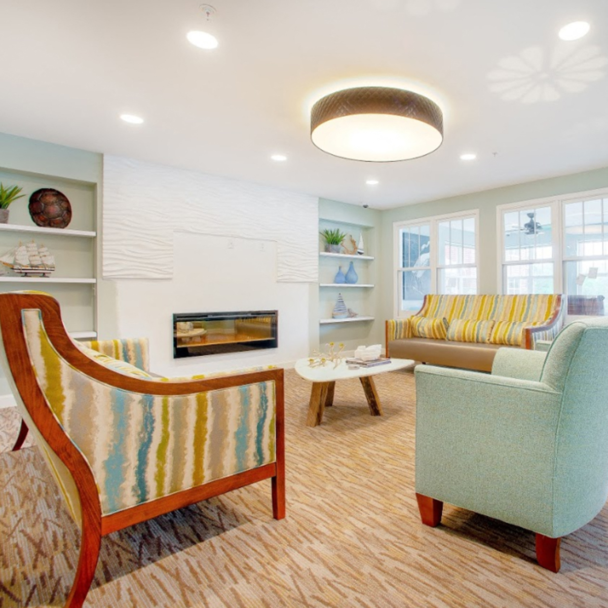 a living room with two chairs and a fireplace