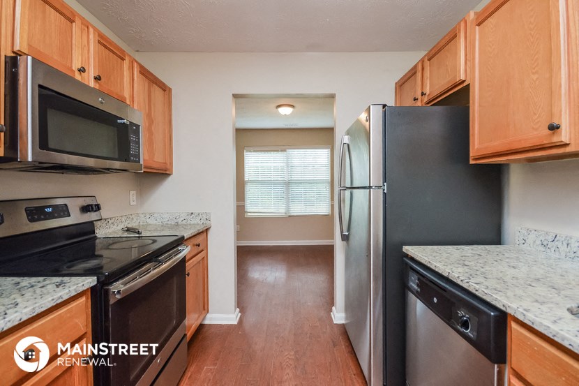 a kitchen with wood cabinets and stainless steel appliances and granite counter tops