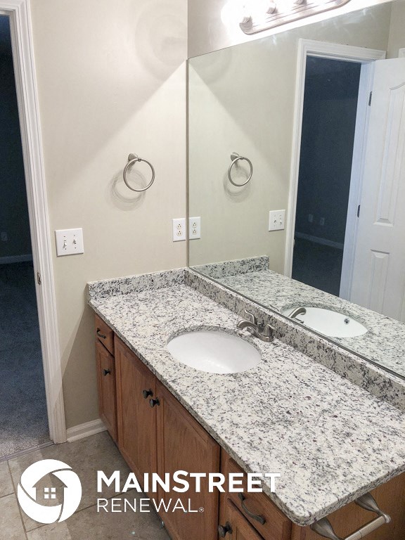 a bathroom with granite counter tops and two sinks