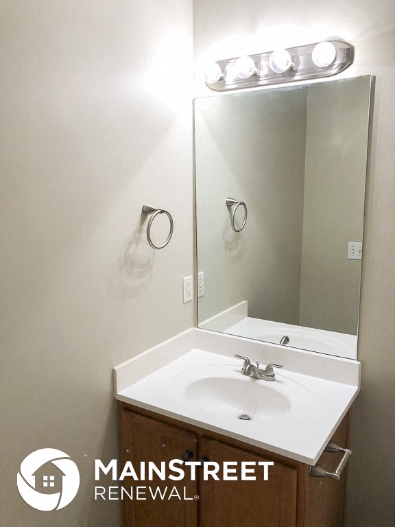 a small bathroom with a sink and a mirror