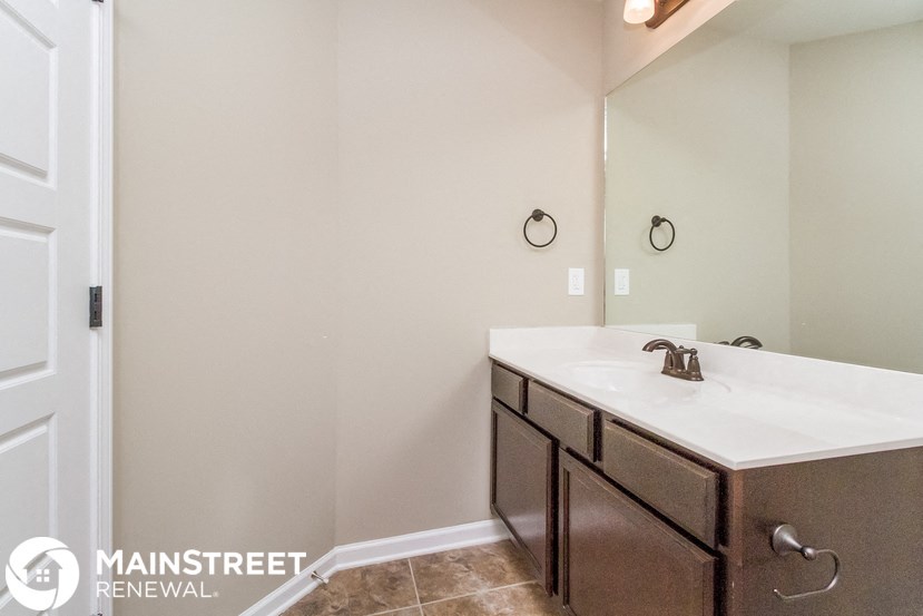 a bathroom with a sink and a mirror and a shower