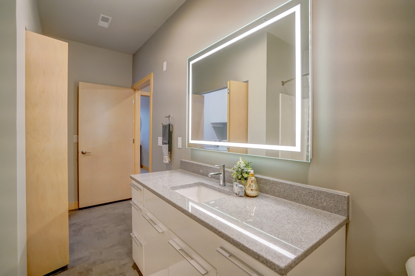 a bathroom with a large mirror and a sink