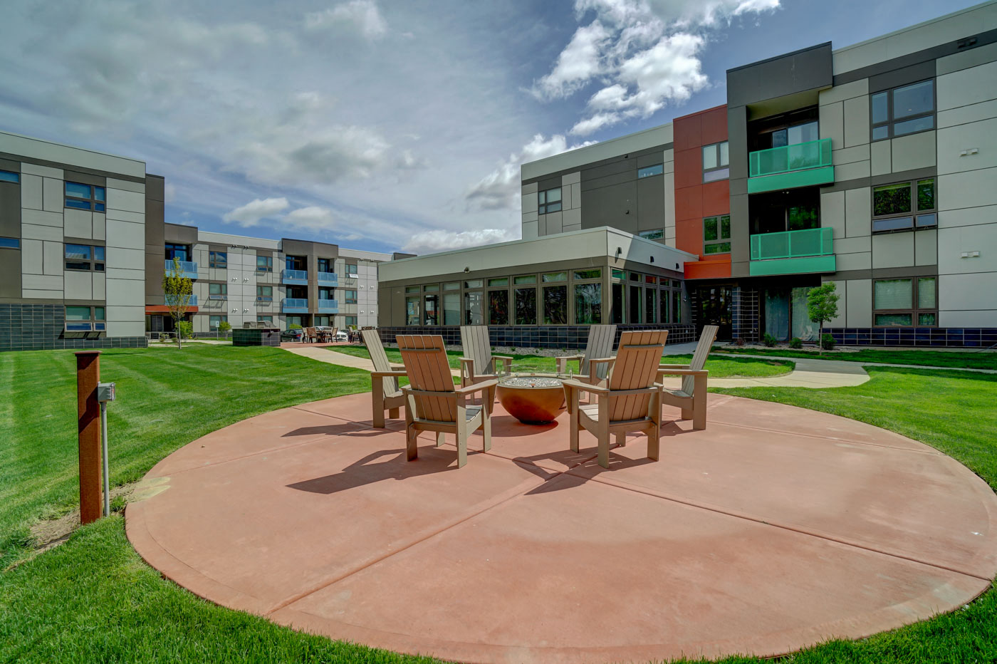 a courtyard with a table and chairs in front of some buildings