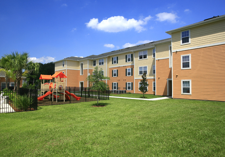 Playground and grassy area at Summerlink Oaks Apartments