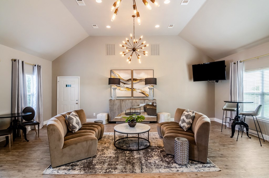 the living room of a home with couches and a table