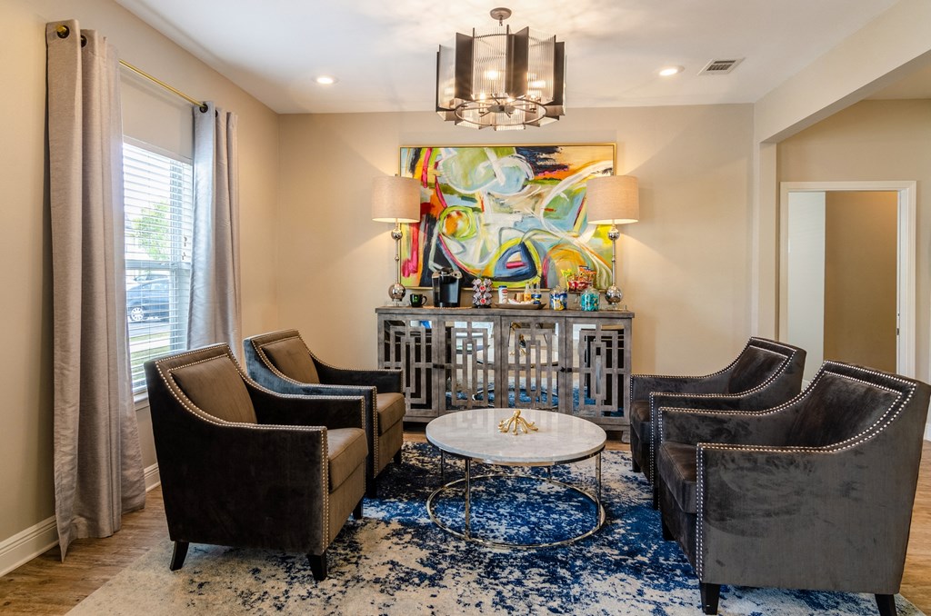 a living room with couches and chairs and a table