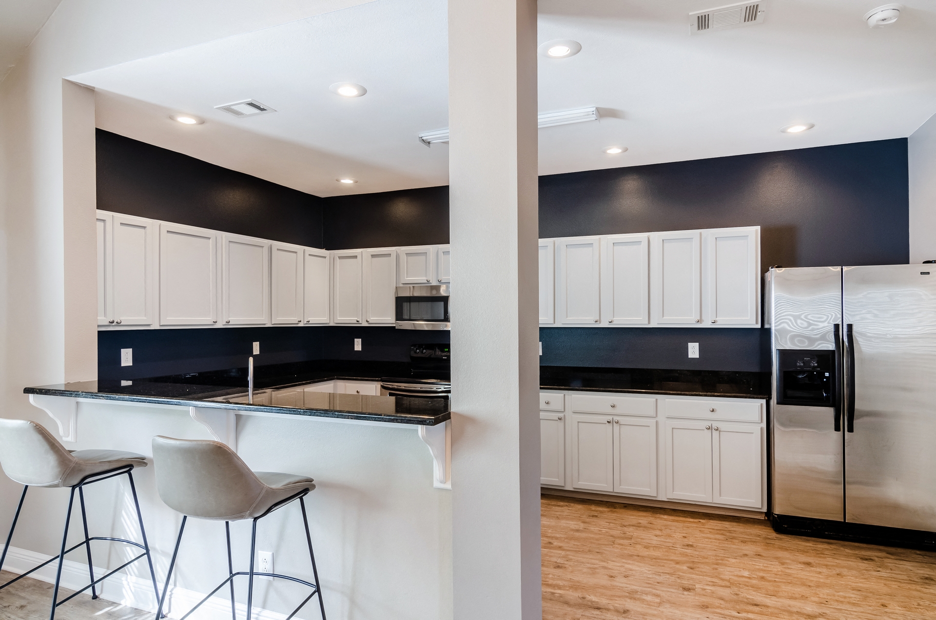 a kitchen with a counter top and a refrigerator