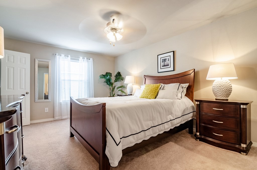 a bedroom with a large bed and a dresser