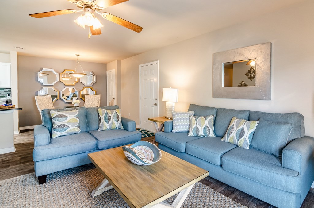 a living room with two blue couches and a coffee table