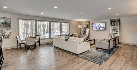 a living room with a couch and chairs and a table