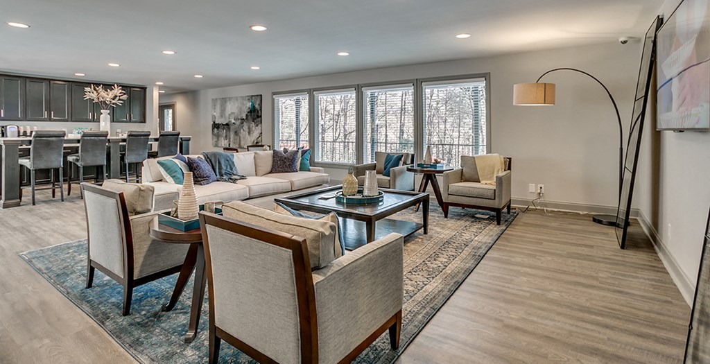 a living room with couches and chairs and a dining room table