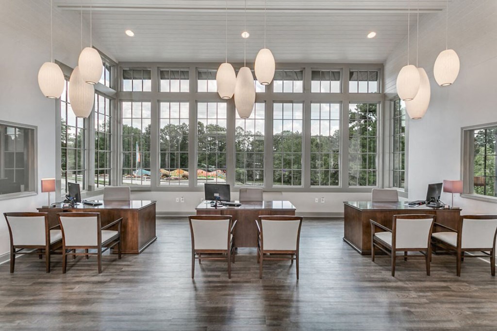 a dining room with large windows and a large table with chairs