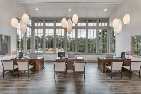 a dining room with large windows and a large table with chairs