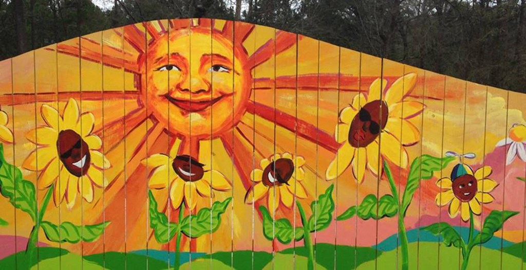 a mural of a sunflower with a face on it
