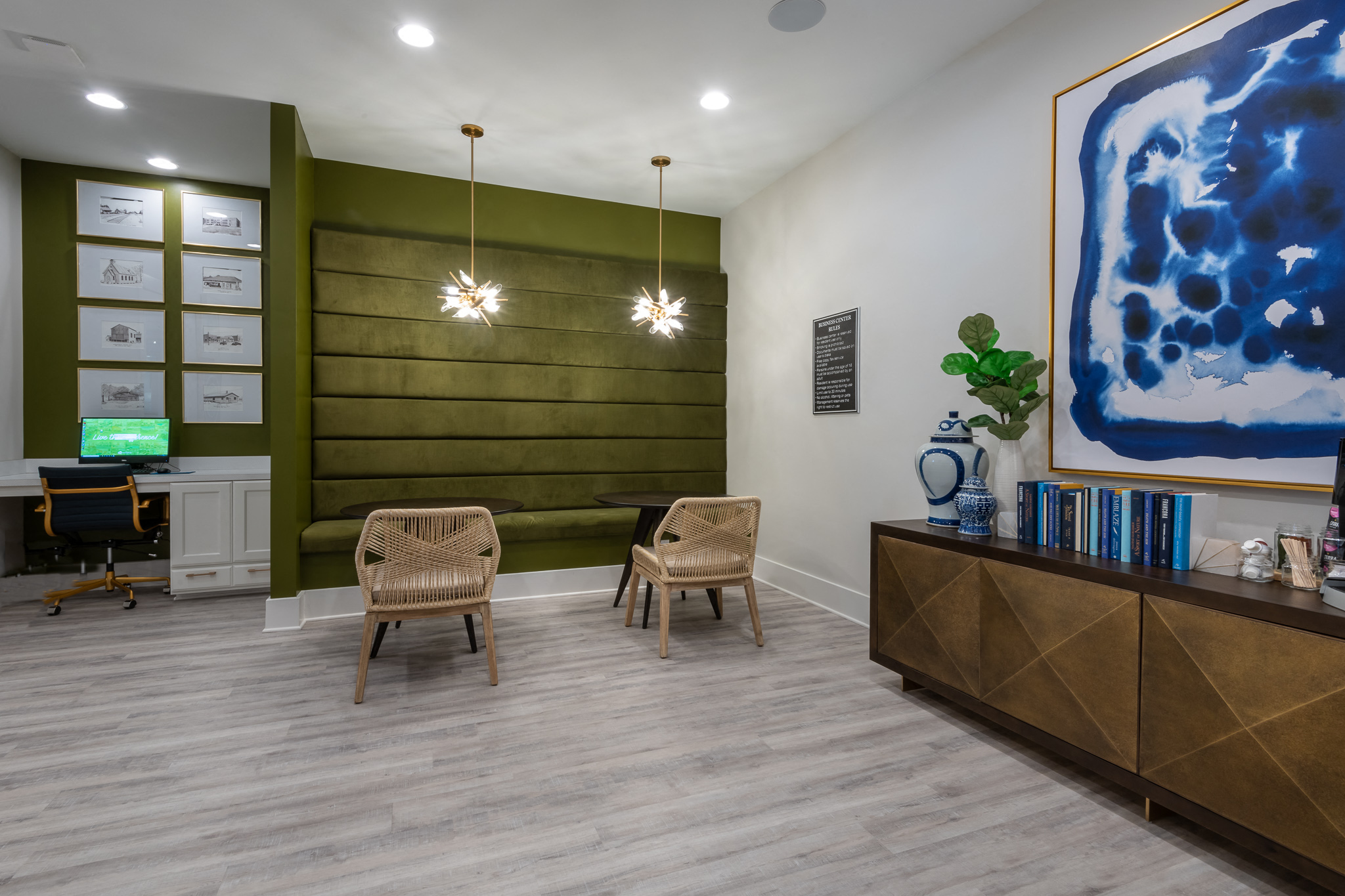 a lobby with two chairs and a reception desk and a blue painting