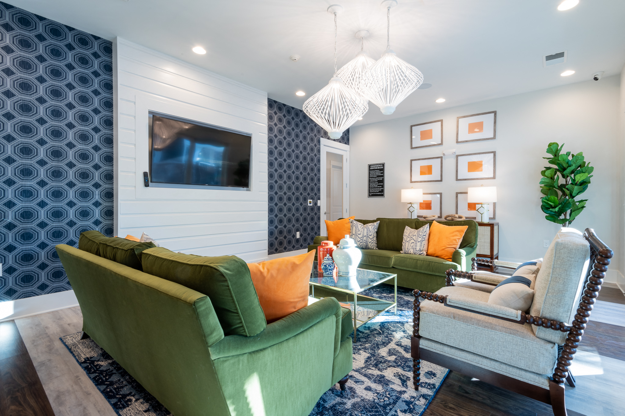 a living room with couches and chairs and a television