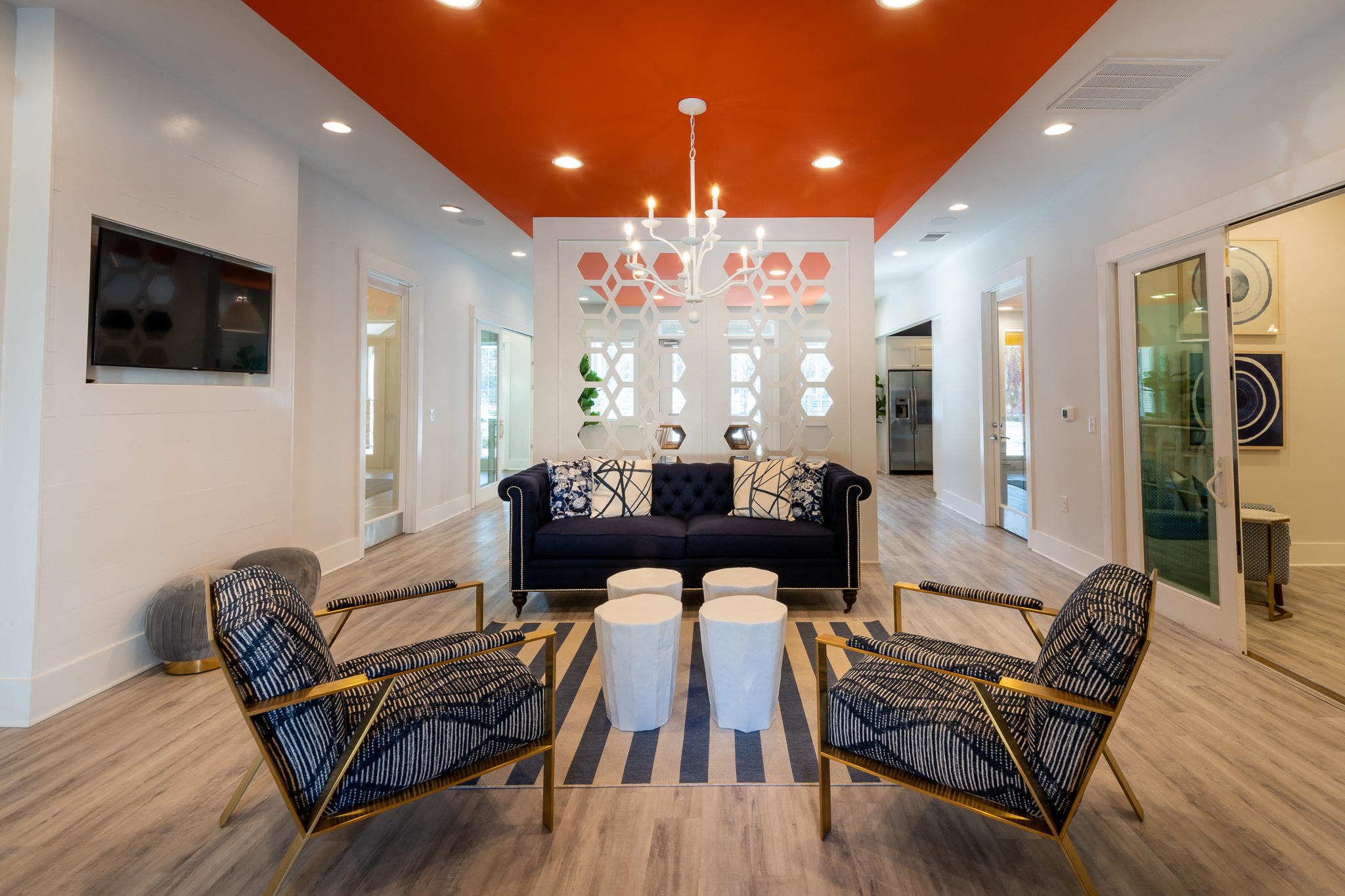 a living room with couches and chairs and a chandelier