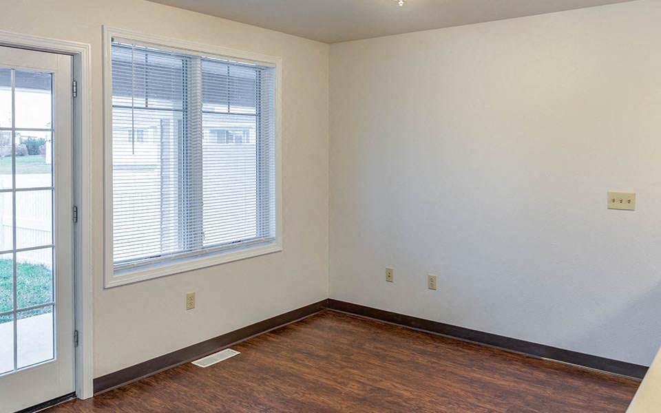 an empty room with a window and a door