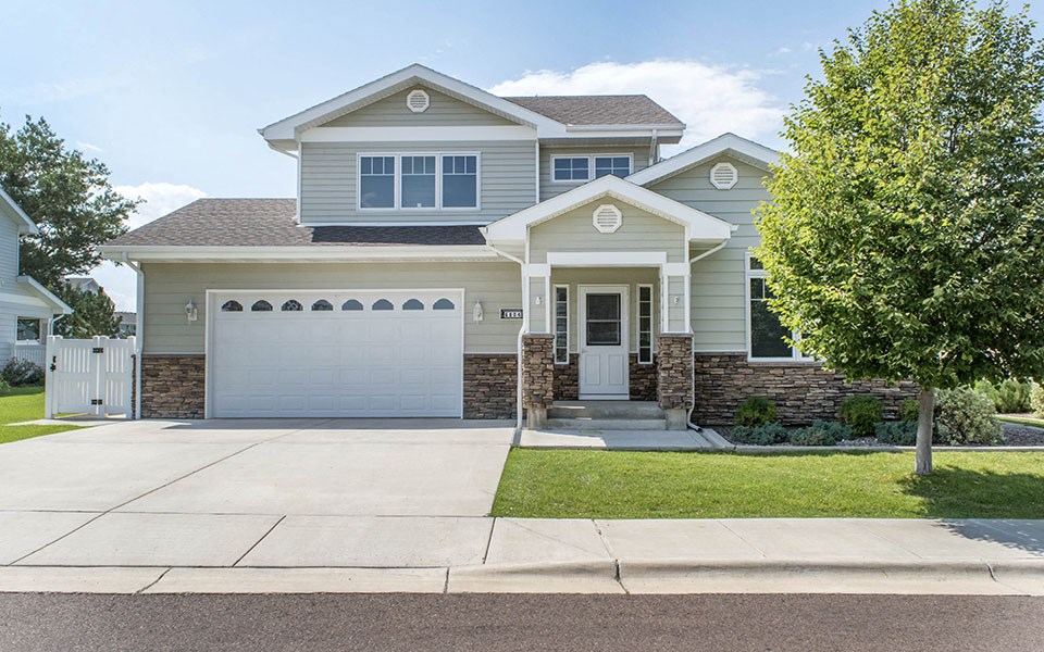 a house with a driveway and a garage door