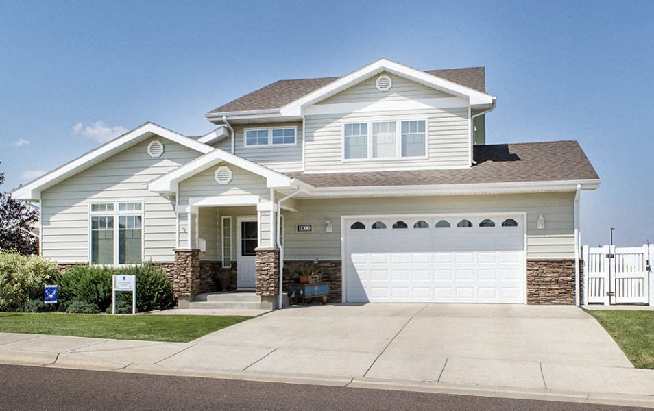 a white house with a white garage door