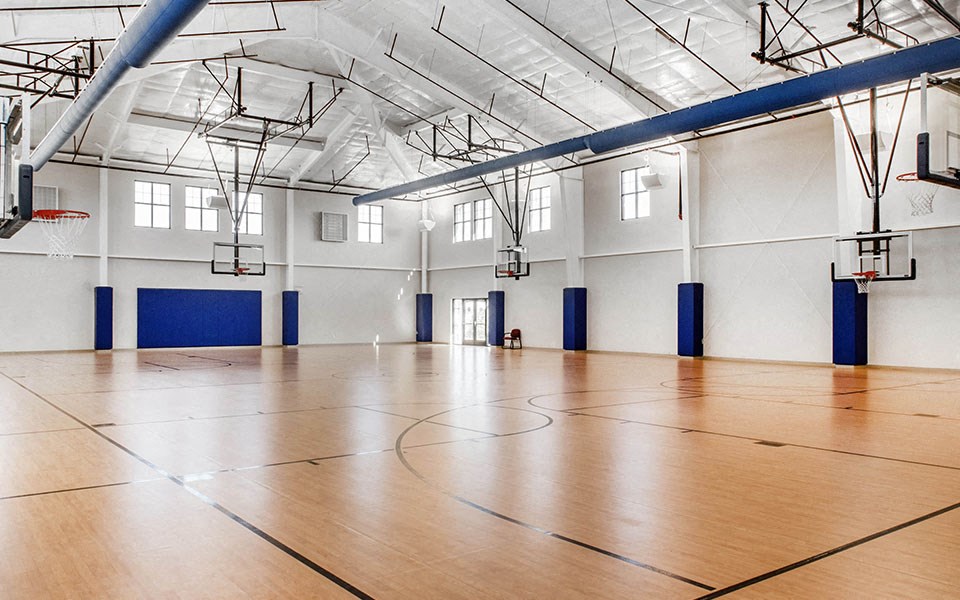 a basketball court in a gym with wood floors