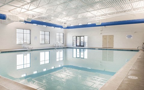 a large swimming pool in a building with a ceiling