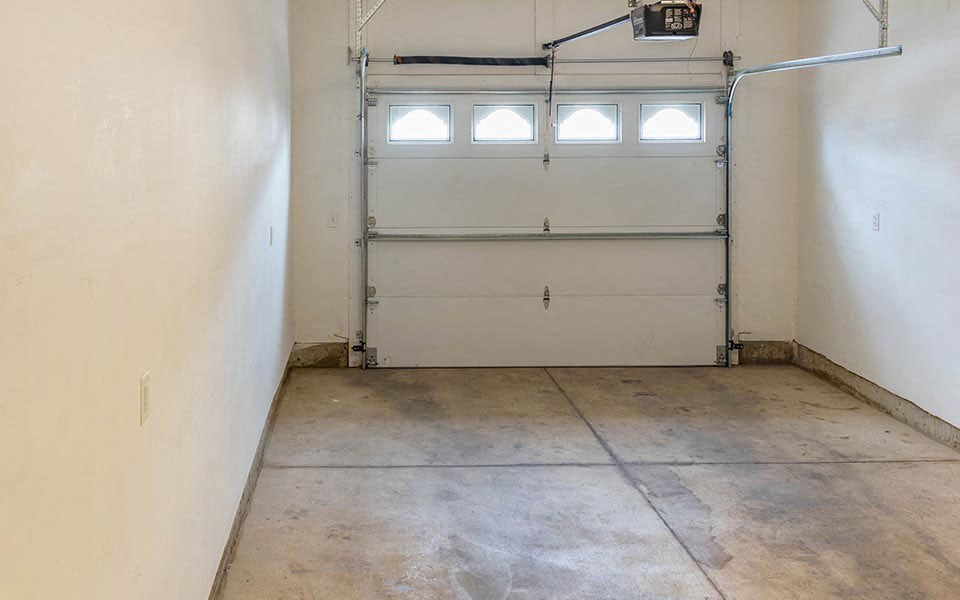an empty room with a white garage door
